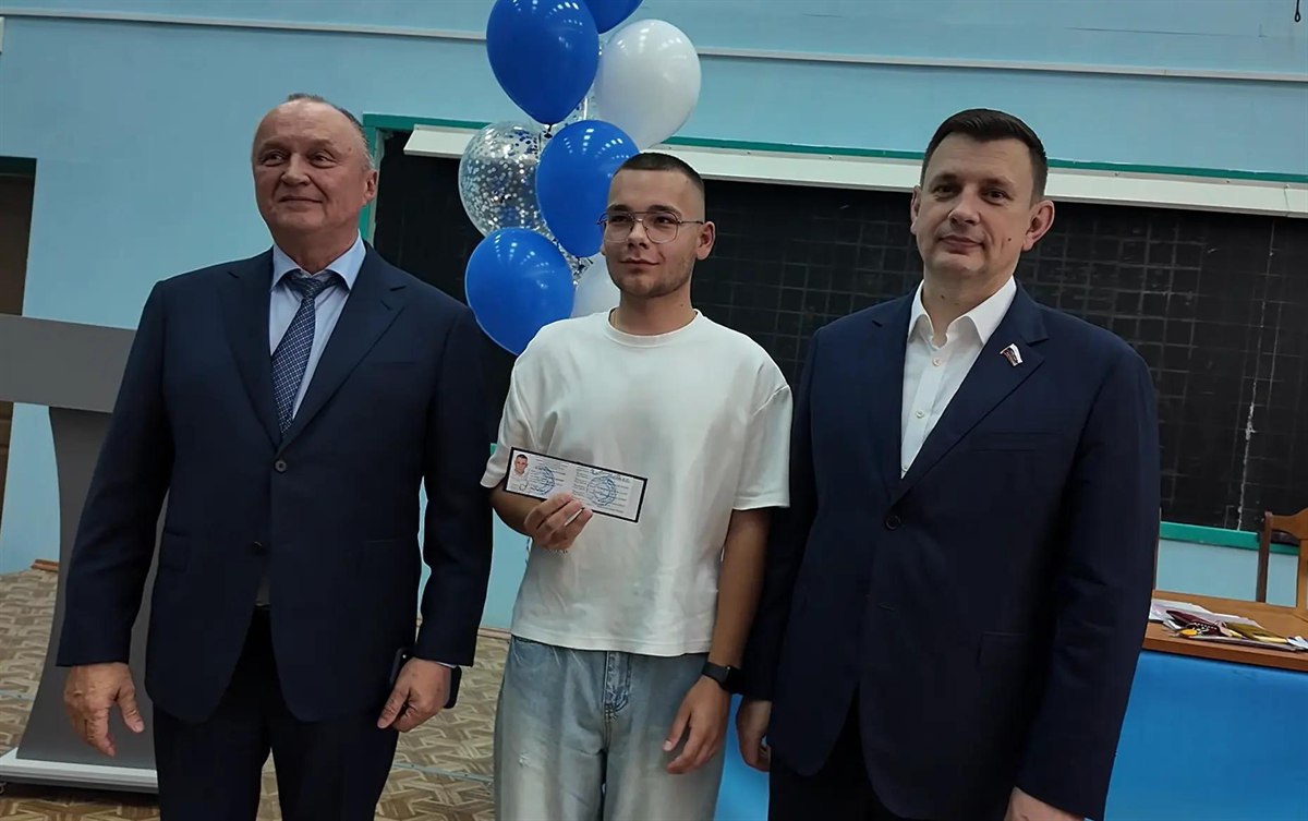 Владимир Первухин и Александр Рем вручают зачётку первокурснику НИ РХТУ